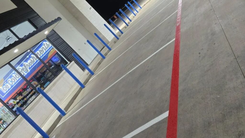 close-up of fire lane striping freshly painted for HEB Fuel