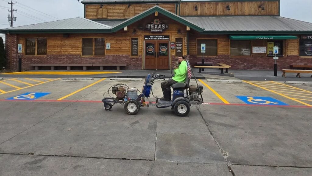 G-FORCE® employee sitting on machine in front of Texas Roadhouse