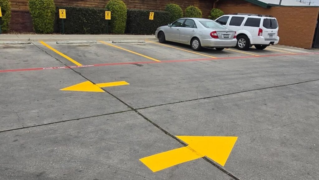freshly painted yellow arrows for Texas Roadhouse parking lot