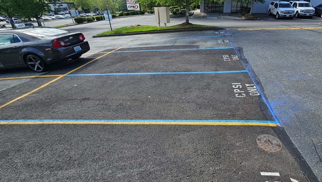 close-up of parking spots with blue lines for NuMotion