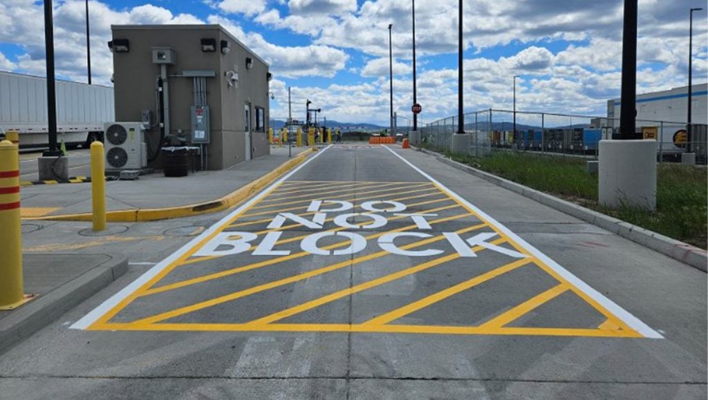 freshly painted yellow marking lines for amazon parking lot