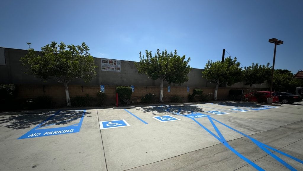 G-FORCE® employees line striping parking spots for Best Western Plus