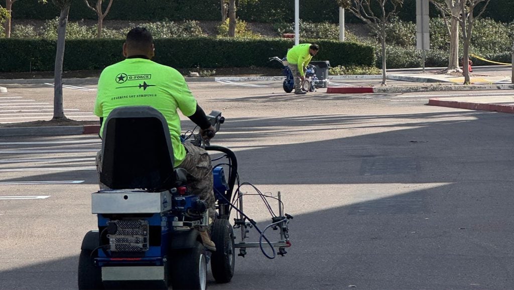 G-FORCE employees line striping OST Omnitron Systems parking lot