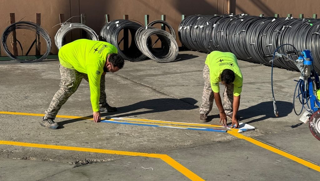 G-FORCE employees freshly painting Brown Pacific parking lot