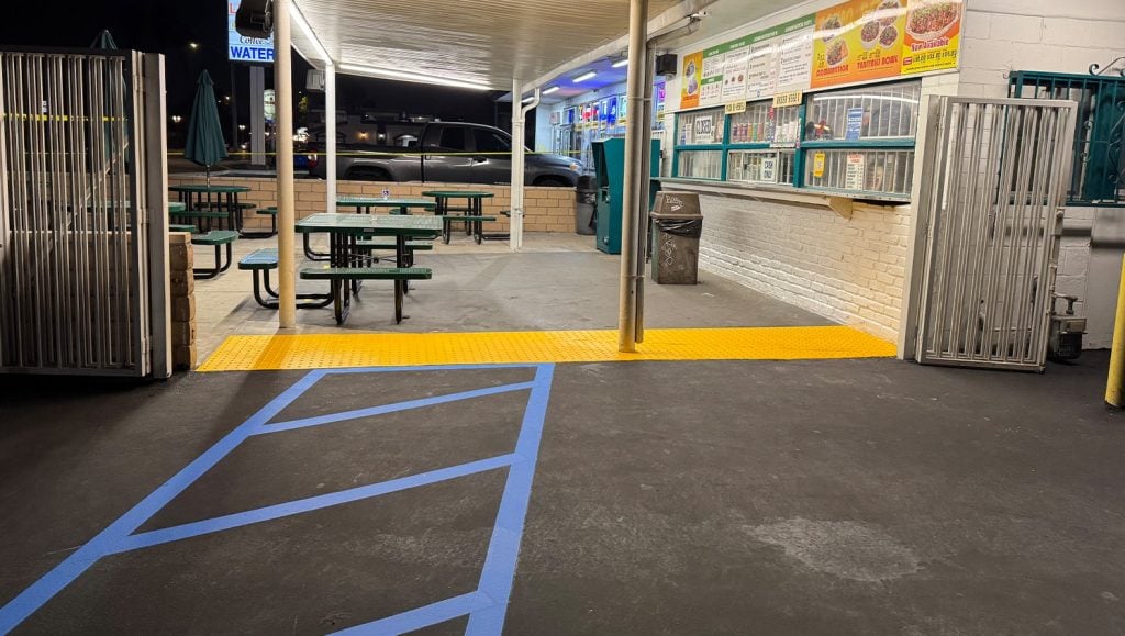 close-up of crosswalk freshly painted for Moe’s 2 parking lot