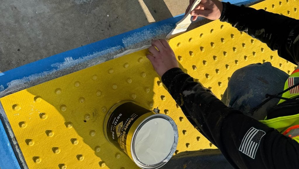 clsoe-up of G-FORCE employee painting