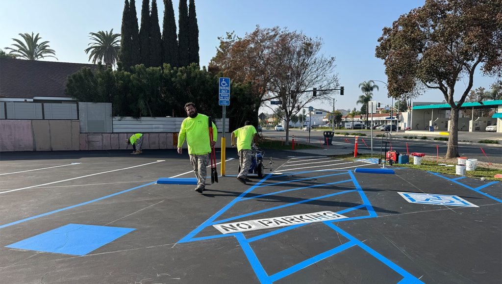 G-FORCE employees freshly painting Moe’s 2 parking lot