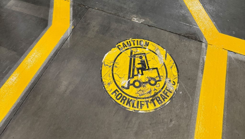 close-up of forklift painting on Sabrosura Foods warehouse flooring