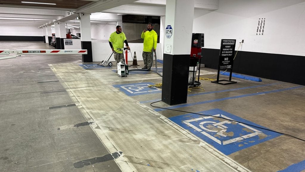 G-FORCE® employees removing faded ada compliance markings