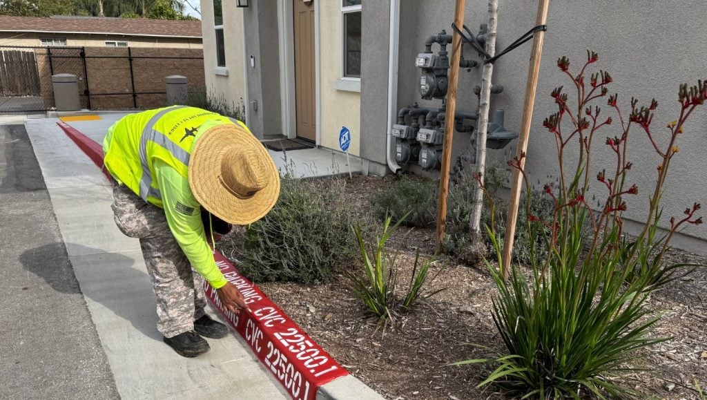 G-FORCE® employee painting fire lane for HOA community parking lot