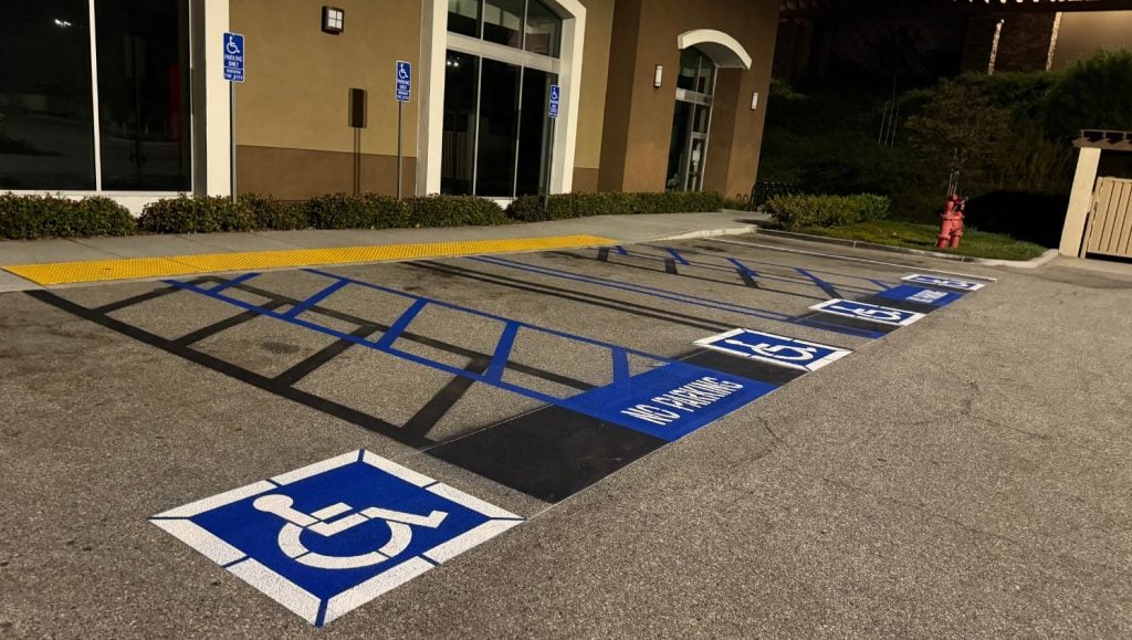 close-up of freshly painted ada compliance parking spots for LA Fitness