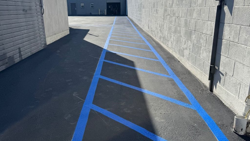 close-up of freshly painted line markings for Quantum Freight Logistics parking lot