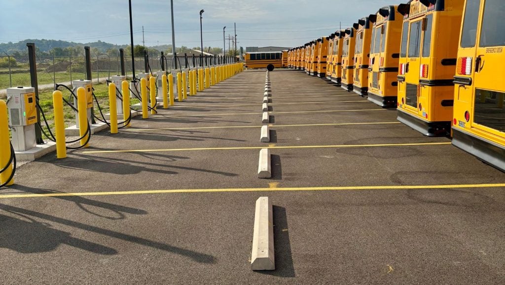 North America Central School Bus parking lot with parking stops installed