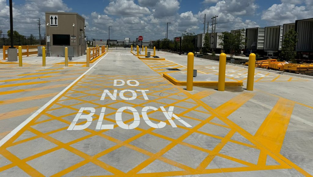 "stop" freshly painted on amazon warehouse parking lot