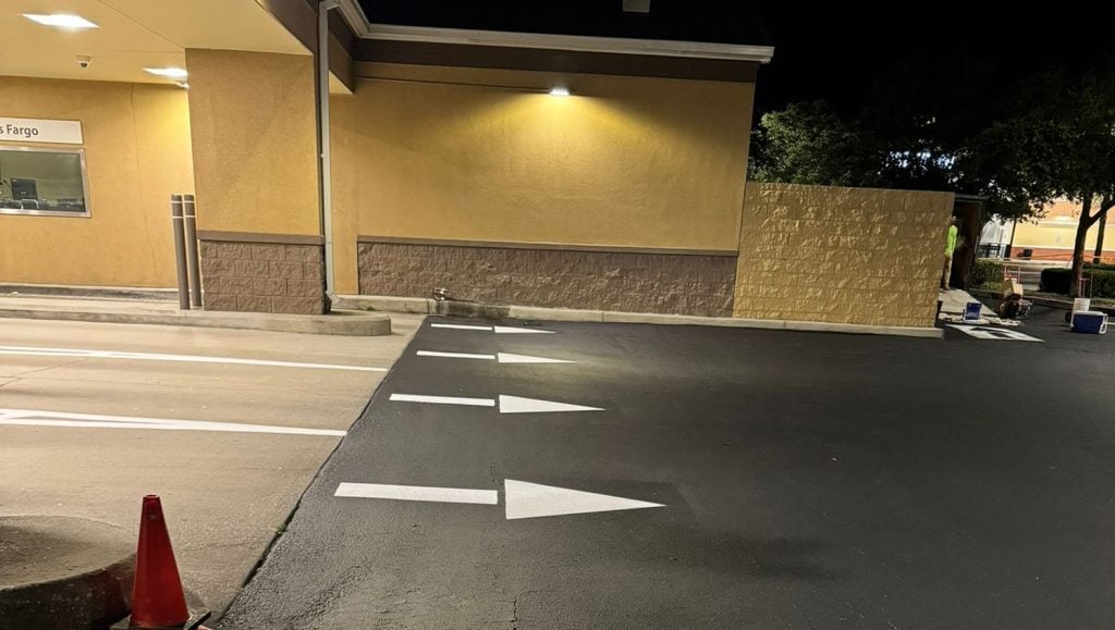close-up asphalt sealcoating and freshly painted lines