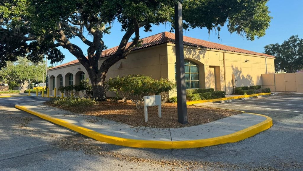 side view of bank of america with freshly painted lines in parking lot