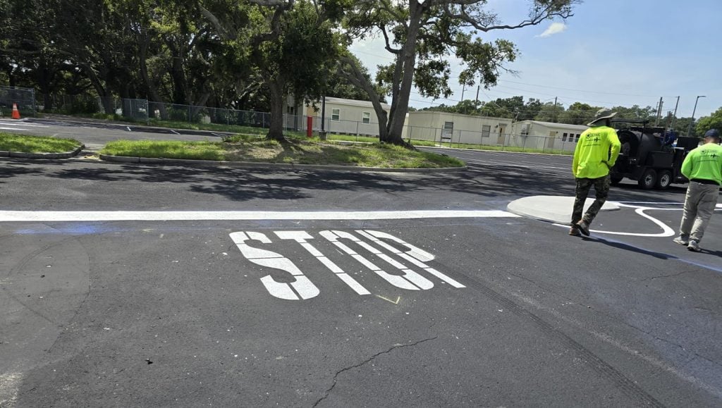 stop painted in white on Corporate Business parking lot