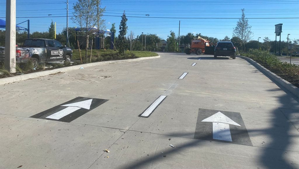 directional arrows painted in car wash parking lot