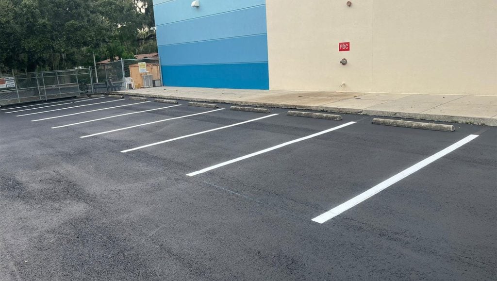 directional pavement markings on fresh sealcoated pavement