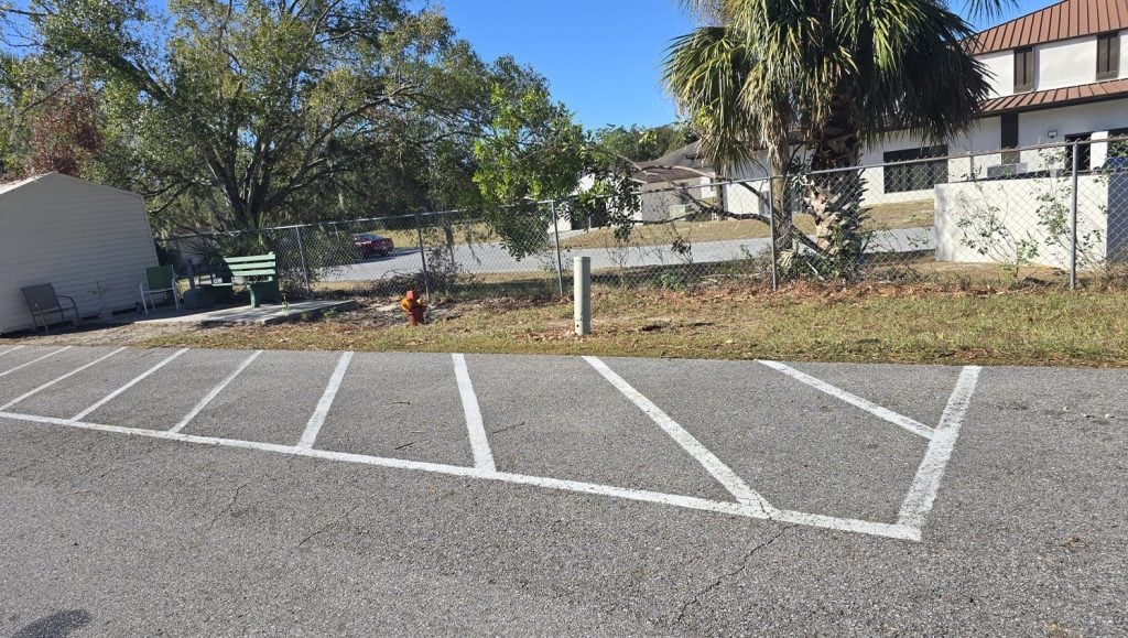 front view of freshly painted line markings for apartment parking lot
