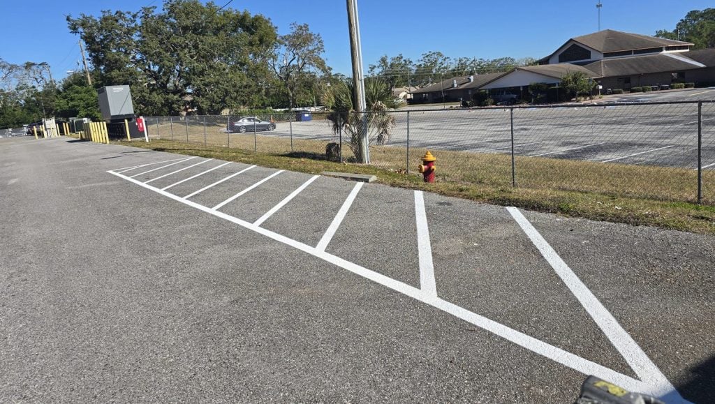 front view of freshly painted line striping for apartment parking lot