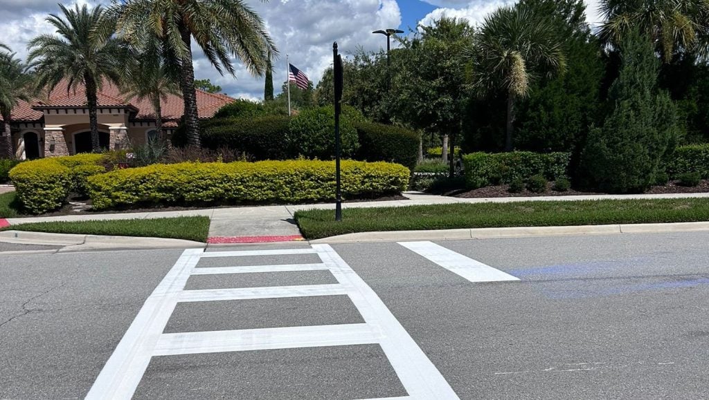 crosswalk freshly painted on pavement in neighborhood