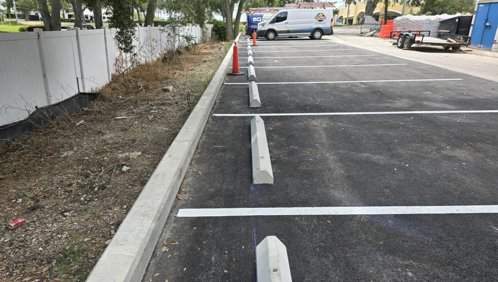 close-up of parking spots freshly painted with parking stops installed