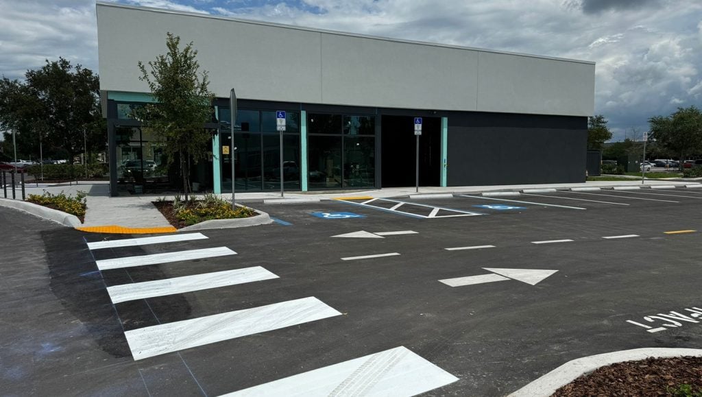 freshly painted white arrows and crosswalk for business office parking lot