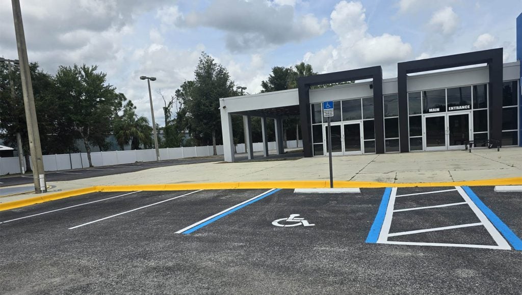 front view of Jayco parking lot with freshly painted ada compliance parking spots