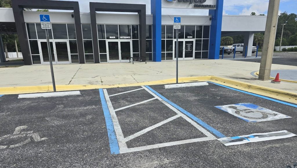 faded ada compliance parking spots at Jayco