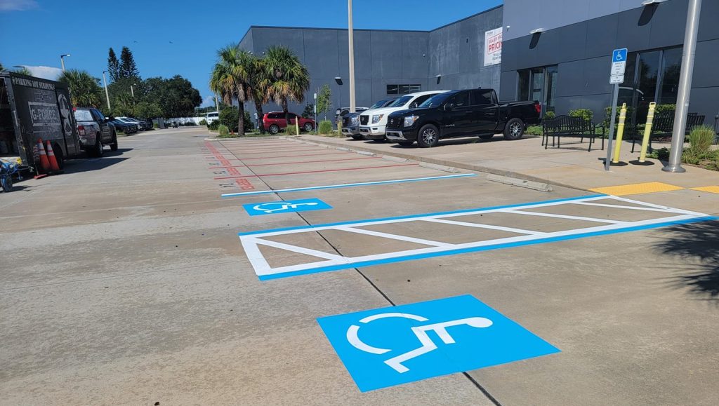 close-up of freshly painted ada compliance parking spots for Nissan Dealership