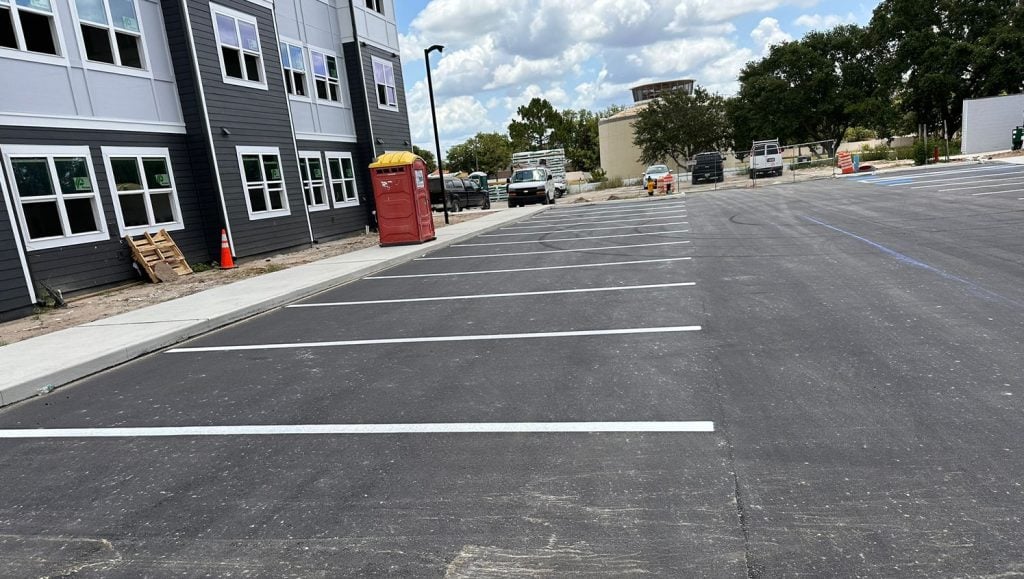 side view of apartment complex with freshly painted line markings