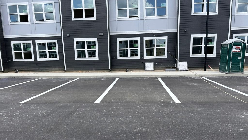 close-up of freshly painted white lines on parking lot
