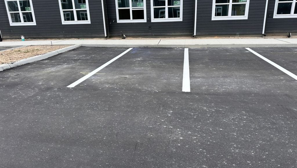 side view of apartment complex with freshly painted lines