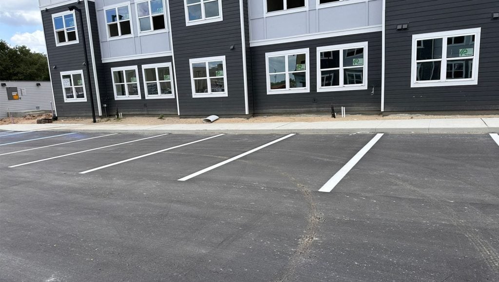 apartment complex with freshly painted lines in parking lot