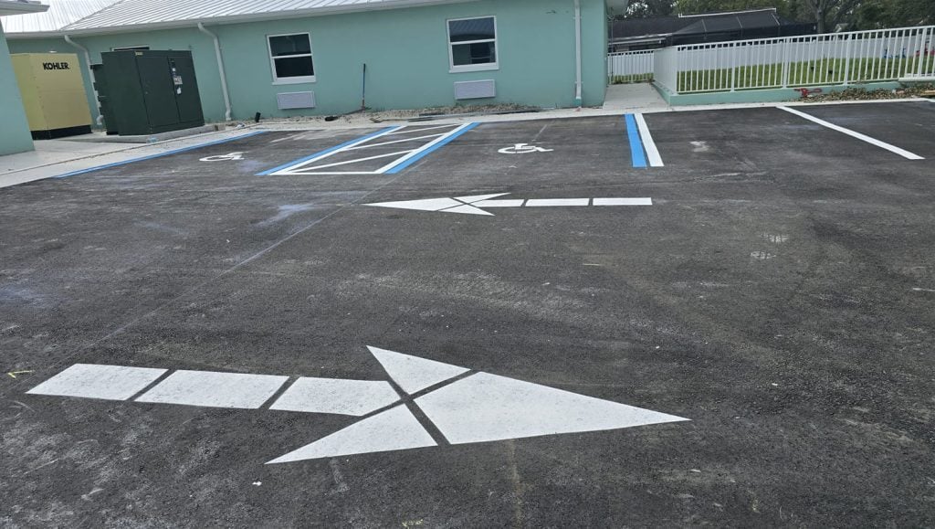close-up of freshly painted arrows and parking spots