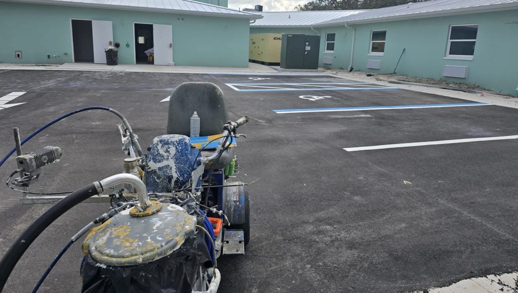 freshly painted parking spots with line machine