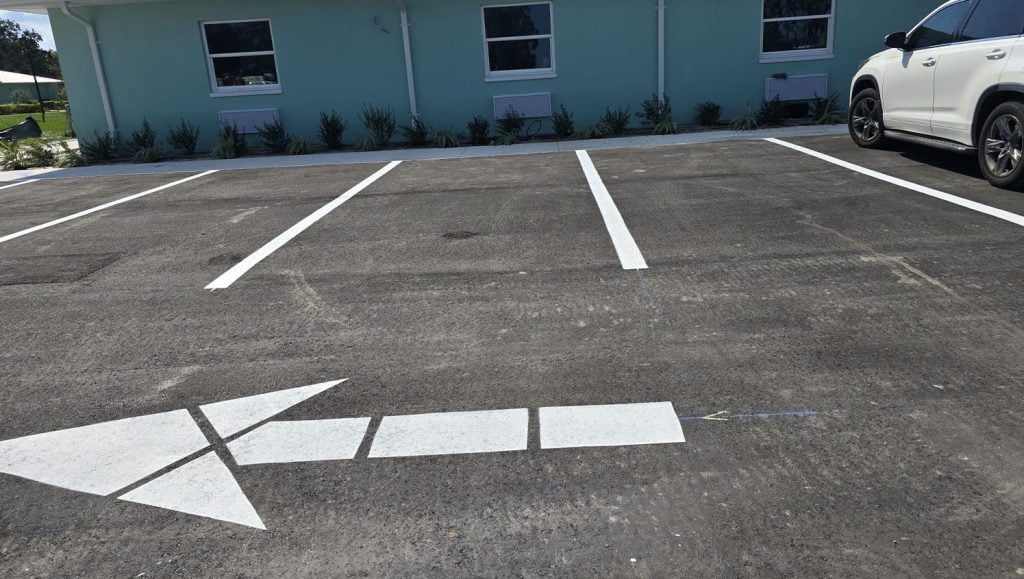 close-up of freshly painted arrow on parking lot for business