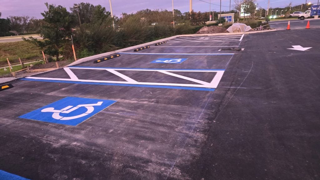 line striping and parking stops installed for business parking lot