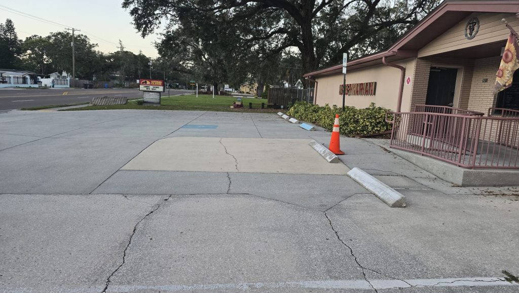 front view of Veterinarian Clinic parking lot with faded lines