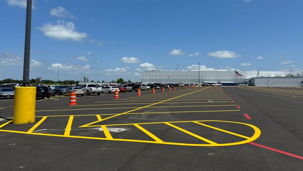 freshly painted yellow lines and arrows for walmart warehouse parking lot