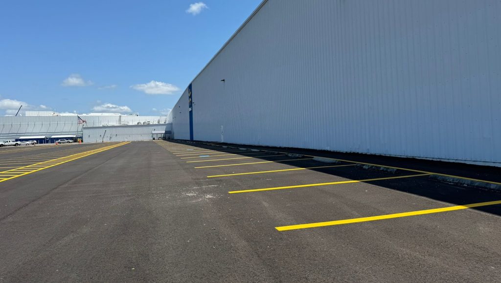 freshly painted yellow lines for walmart warehouse parking lot