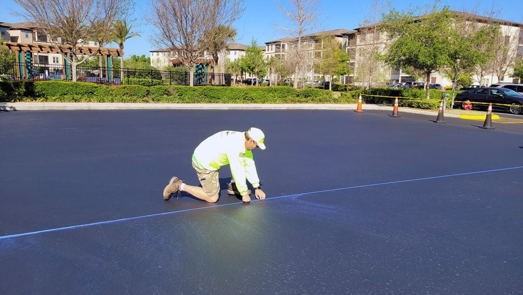worker kneeling on the pavement