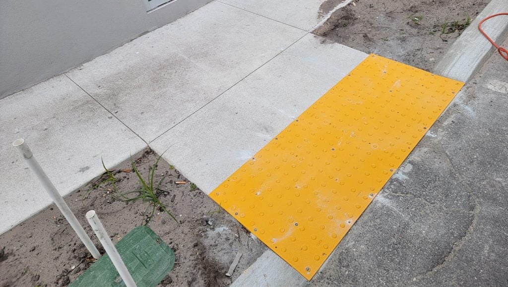 yellow ada mat installation for Health Care Facility parking lot