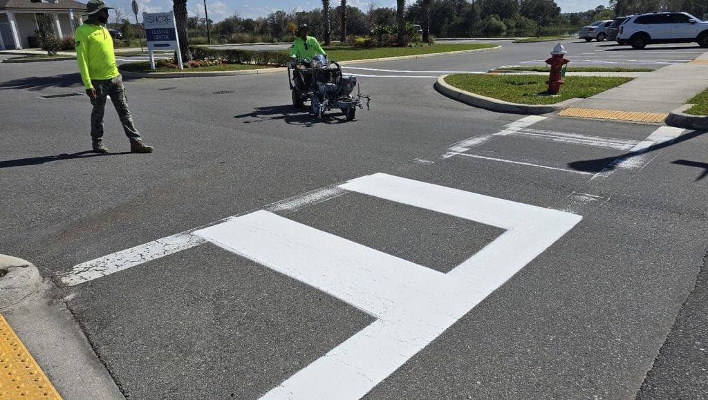 G-FORCE® employees line striping apartment complex parking lot