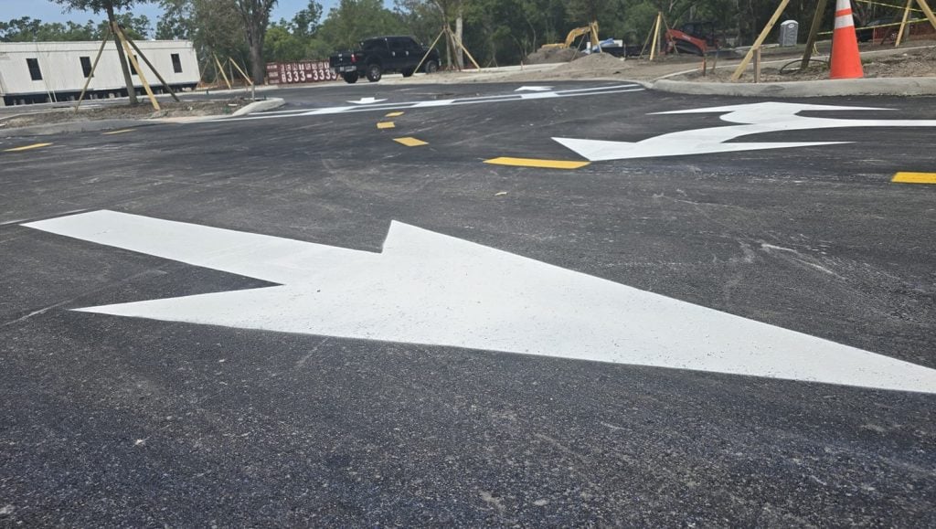 close-up of a white arrow freshly painted for business parking lot