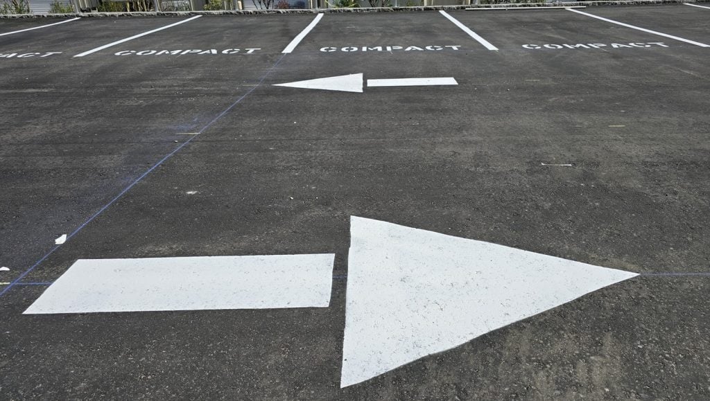 white freshly painted arrows for Home 2 Suites