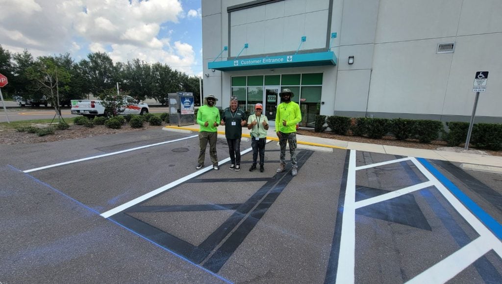 multiple people smiling in front of U-Haul warehouse