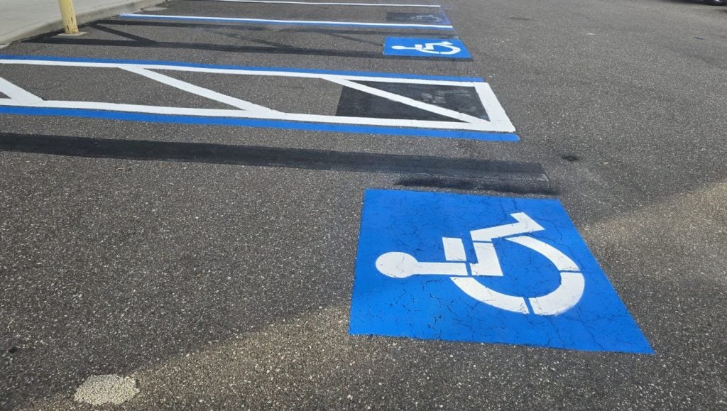 close-up of ada compliance parking spots freshly painted for business parking lot