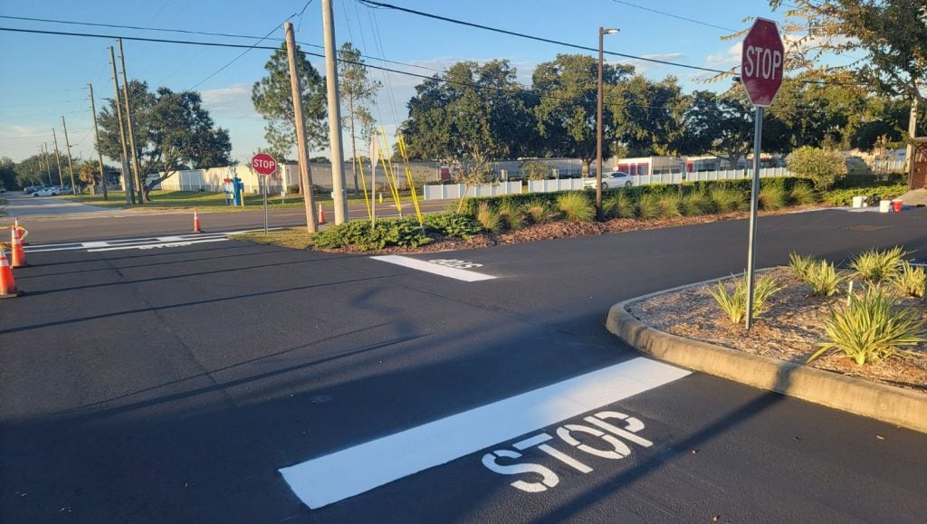 "stop" freshly painted on Trinity Assisted Living parking lot